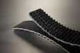 Conveyor belt folded in half to show the black rough top pvc cover and the black fabric bottom