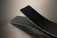 Conveyor belt folded in half to show the black pvc cover and the black fabric bottom