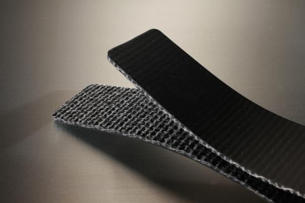 Conveyor belt folded in half to show the black pvc cover and the black fabric bottom