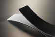 Conveyor belt folded in half to show the black ribbed top pvc cover and the white fabric bottom